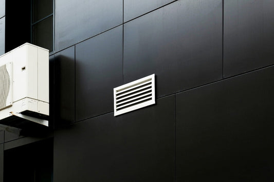 A wall mounted air conditioner on the side of a building